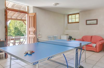 Games room with table tennis and doors leading out to swimming pool